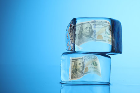 Ice cubes on light blue background, space for text. Frozen objectsの写真素材