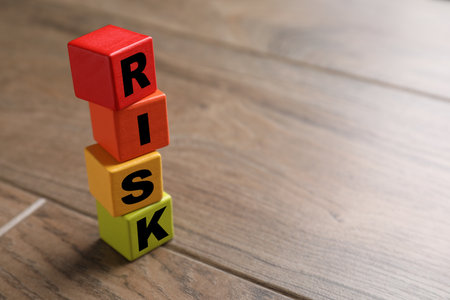Risk word make of wooden cubes on wooden tableの写真素材