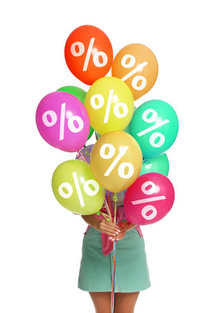 Woman holding balloons with percent signs on white background.の写真素材
