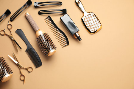 Different hair styling tools on beige background, flat lay. Space for textの写真素材