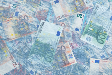 Money frozen. Many euro bills under iceの写真素材