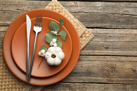 Beautiful table setting with autumn decor on wooden background, top view. Space for textの写真素材
