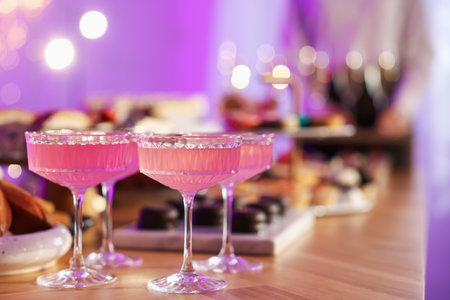 Different delicious desserts, drinks on buffet table and waiter, selective focusの写真素材