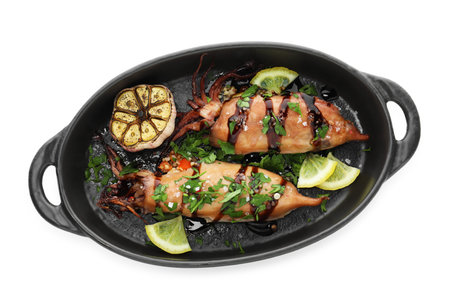 Tasty cooked squids with lemon, sauce and garlic isolated on white, top view