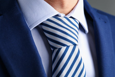 Man in suit with stylish necktie on gray background, closeupの写真素材