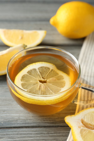 Aromatic tea in cup and lemons on wooden table, closeupの写真素材