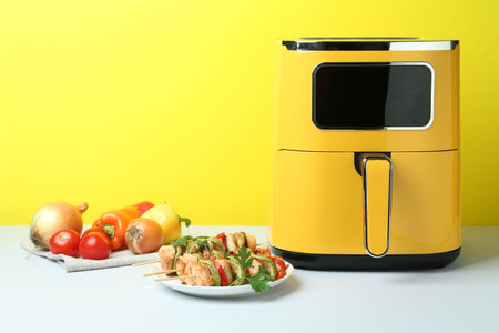 Tasty skewers with chicken, vegetables, parsley on white table. Space for textの写真素材