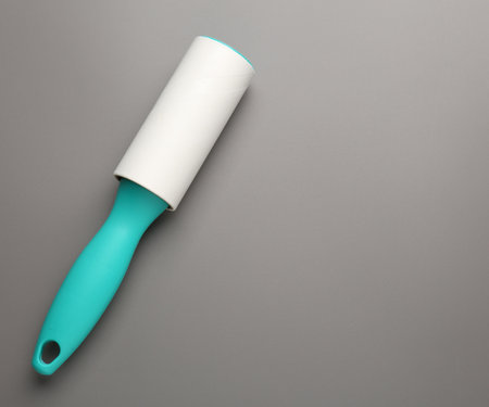 One lint roller on gray background, top view. Space for textの写真素材