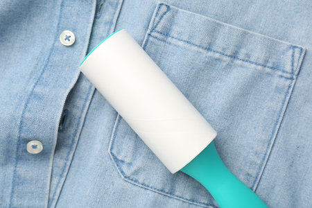 Sticky lint roller on shirt, top viewの写真素材
