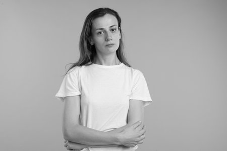 Frustrated woman on gray background. Black and white effectの写真素材