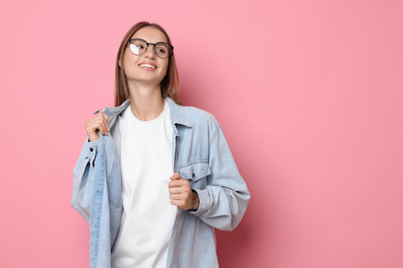 Woman wearing white t-shirt on pink background. Mockup for designの写真素材