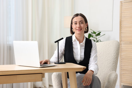 Podcast host recording talk show indoors, view from cameraの写真素材