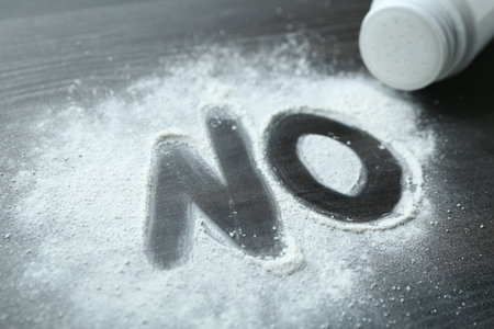 Word NO made of talcum powder and container on black wooden background, closeupの写真素材