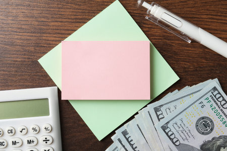 Alimony. Paper notes, money, pen and calculator on wooden table, flat layの写真素材