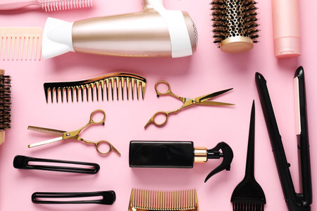Different hair styling tools on pink background, flat layの写真素材