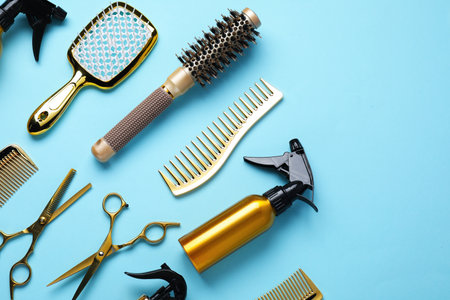 Different hair styling tools on light blue background, flat lay. Space for textの写真素材