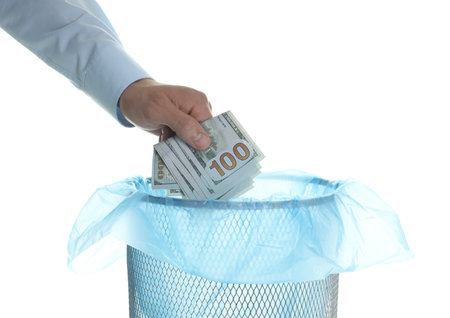 Man throwing money into trash bin on white background, closeupの写真素材