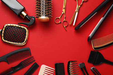 Different hair styling tools on red background, flat lay. Space for textの写真素材
