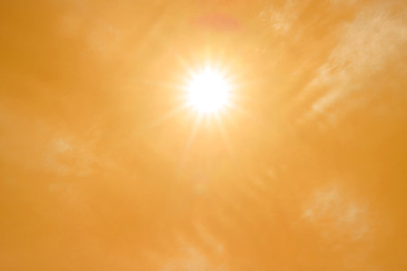 Bright sun in orange sky during hot summer weather. Extremely high temperatureの写真素材