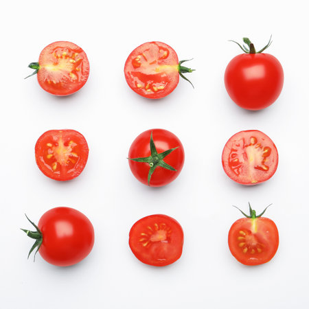 Whole and cut red tomatoes on white background, flat layの写真素材