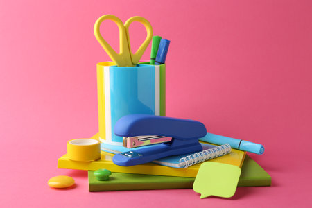 Stapler and other stationery on pink backgroundの写真素材