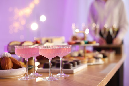 Different delicious desserts, drinks on buffet table and waiter, selective focusの写真素材