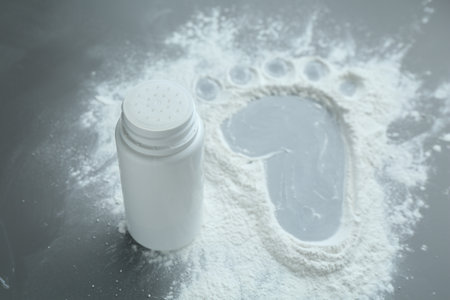 Baby foot made of talcum powder and plastic bottle on grey background, closeupの写真素材