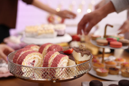 Different delicious desserts and people at buffet table, selective focusの写真素材
