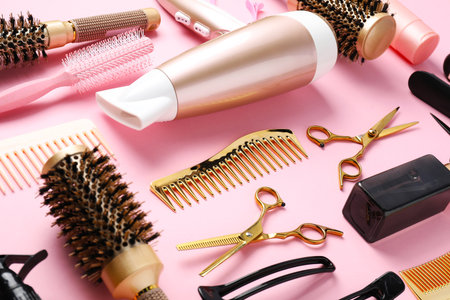 Different hair styling tools on pink background, closeupの写真素材