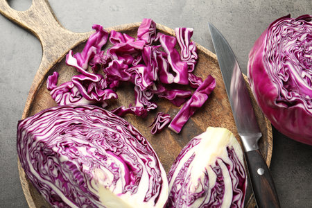 Cut red cabbage and knife on grey table, flat layの写真素材