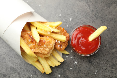 British Traditional Fish and chips with sauce on grey table, flat layの写真素材