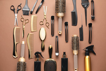 Different hair styling tools on brown background, flat layの写真素材