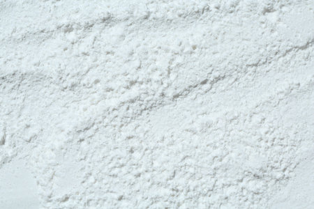 Texture of dry talcum powder as background, top view