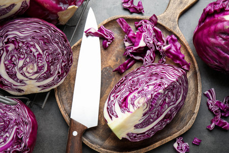 Fresh red cabbages and knife on gray table, flat layの写真素材