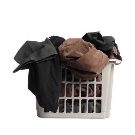 Plastic basket laundry full of clothes isolated on whiteの写真素材