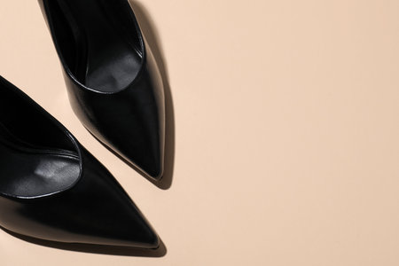 Pair of stylish high heeled shoes on beige background, flat lay. Space for textの写真素材