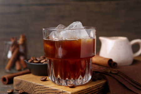 Tasty iced coffee and beans on wooden table, closeupの写真素材