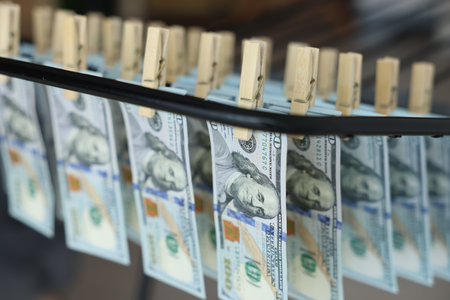 Money laundering. Banknotes hanging on drying rack indoors, closeupの写真素材
