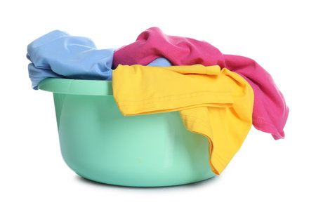 Plastic basin with laundry isolated on whiteの写真素材