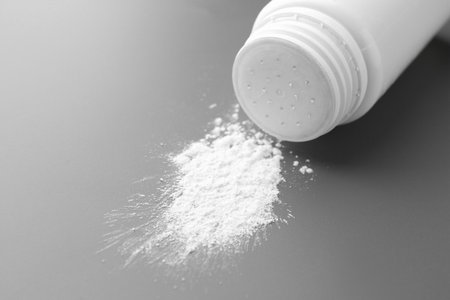 Talcum powder and plastic bottle on gray background, closeupの写真素材