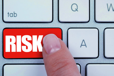 Woman pressing red button with word Risk on keyboard, closeup