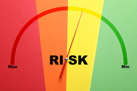 Arrow indicating level of risk on scale from maximum to minimum. Colorful background, top viewの写真素材