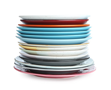 Stack of different ceramic plates isolated on whiteの写真素材
