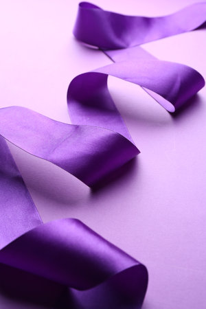 Beautiful ribbon on violet background, closeup viewの写真素材