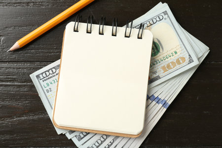 Alimony. Notebook, money and pencil on wooden table, flat layの写真素材