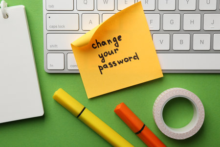 Note with phrase Change your password, keyboard and stationery on green background, flat layの写真素材