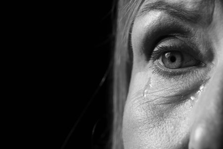 Senior woman crying on dark background, closeup. Black and white effectの写真素材