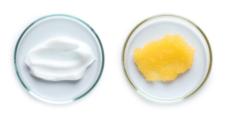 Petri dishes with cosmetic products on white background, top view