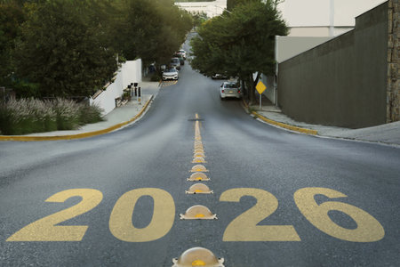 Yellow written numbers on asphalt road in cityの写真素材