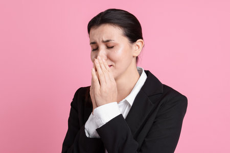 Businesswoman in suit on pink backgroundの写真素材